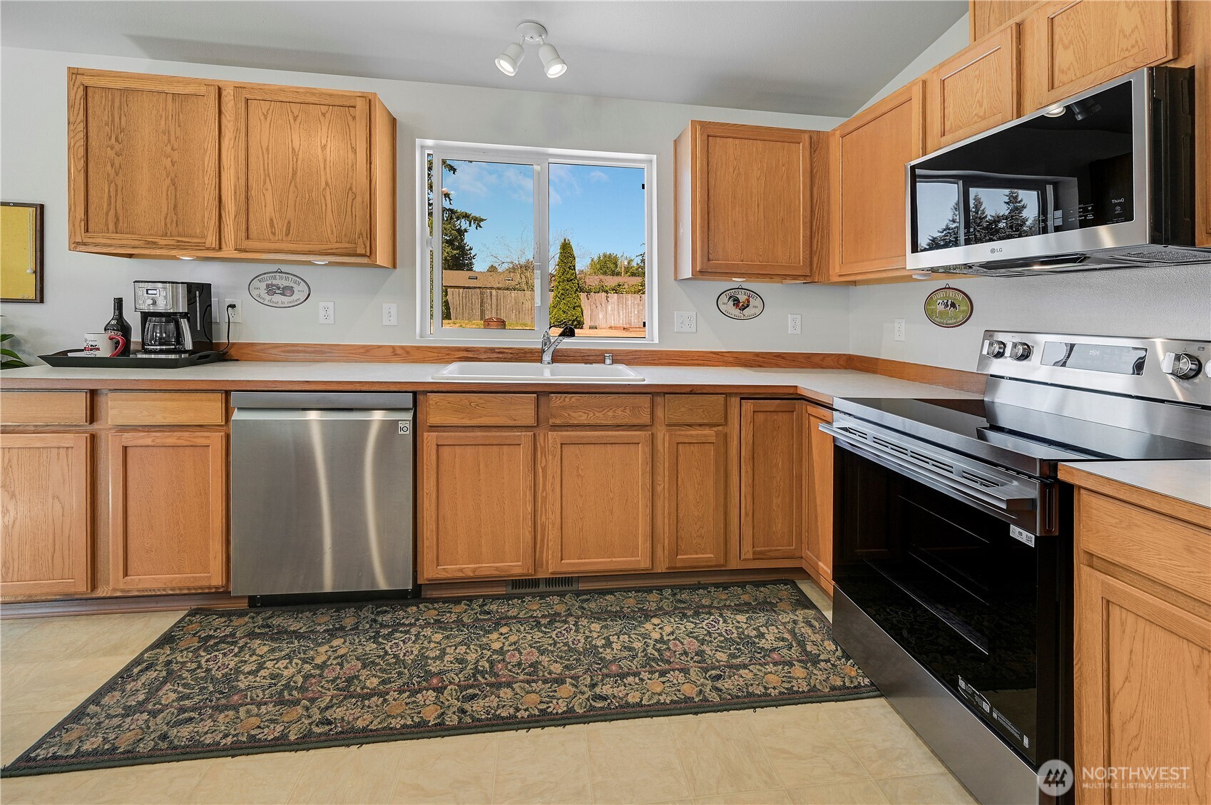 31 2nd Street Port Hadlock, WA 98339 - Photo 10 of 38 a kitchen with stainless steel appliances granite countertop a sink stove and microwave