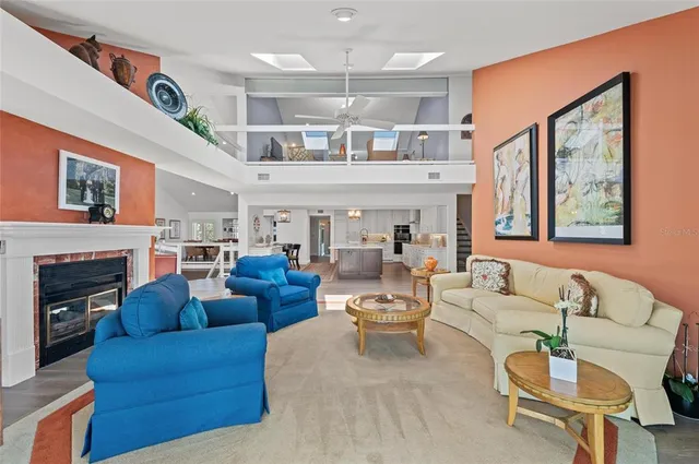 a dining room with furniture a fireplace and chandelier