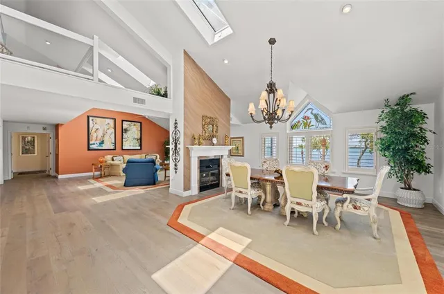a spacious bedroom with a bed and a chandelier
