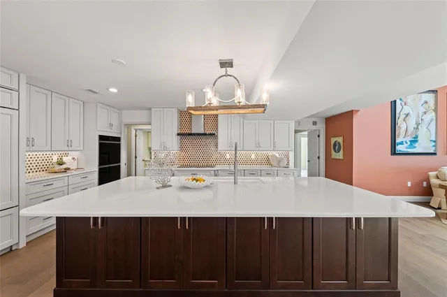 a bathroom with a granite countertop sink a toilet and a mirror