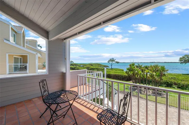 a view of a swimming pool with lawn chairs and a floor to ceiling window