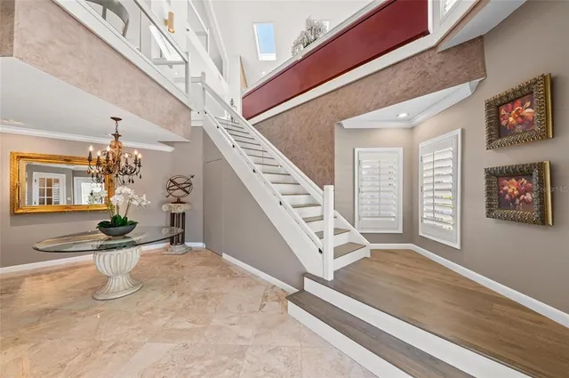 a living room with furniture a fireplace and a large window
