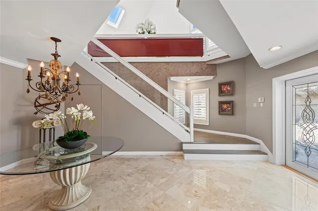 a living room with furniture a couch and potted plants