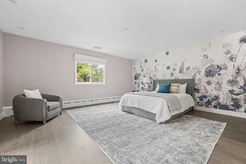 a bedroom with a bed and a chair