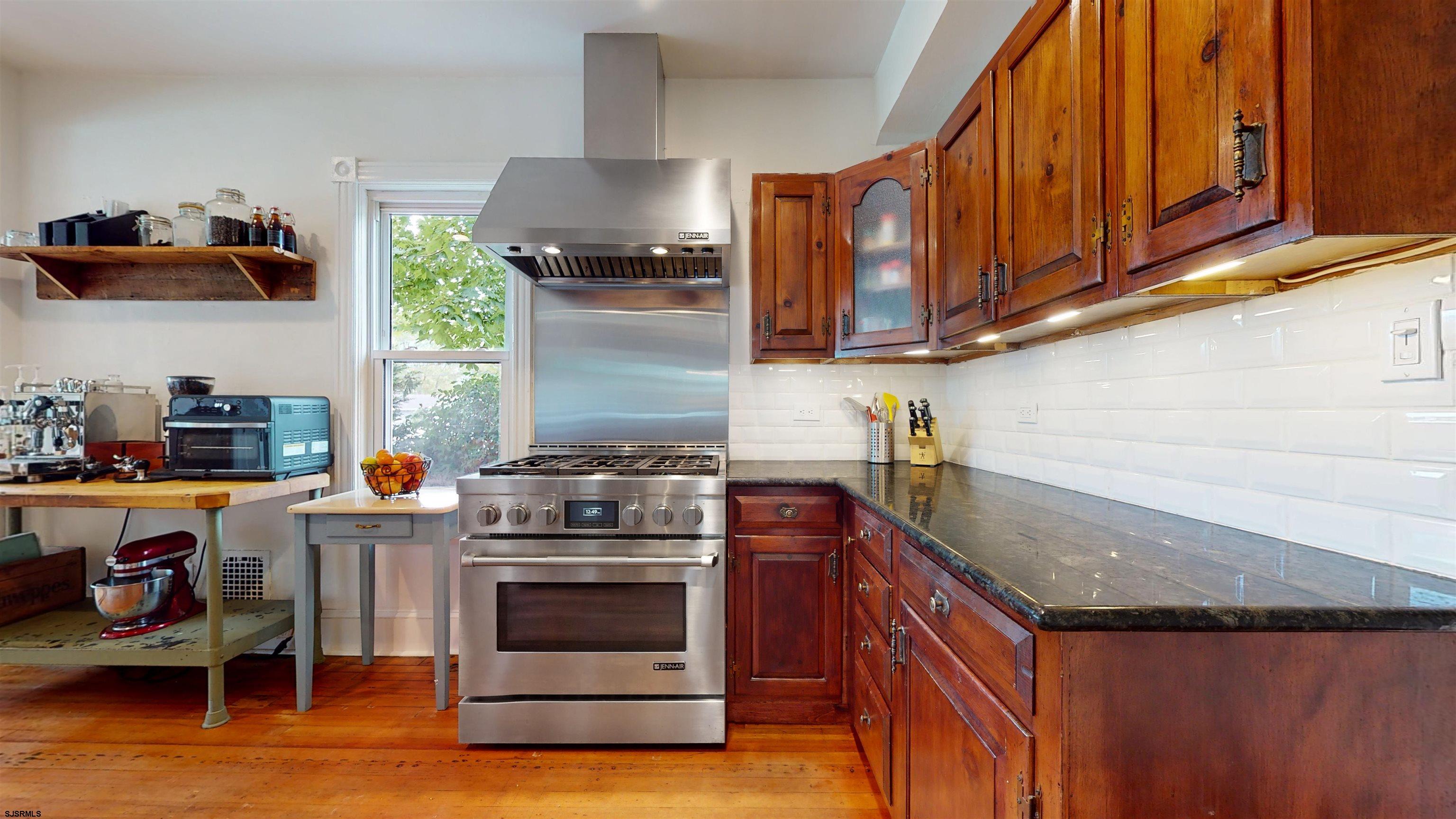 1409 Shore Road Northfield, NJ 08225 - Photo 18 of 50 a kitchen with stainless steel appliances granite countertop a stove a sink and a microwave