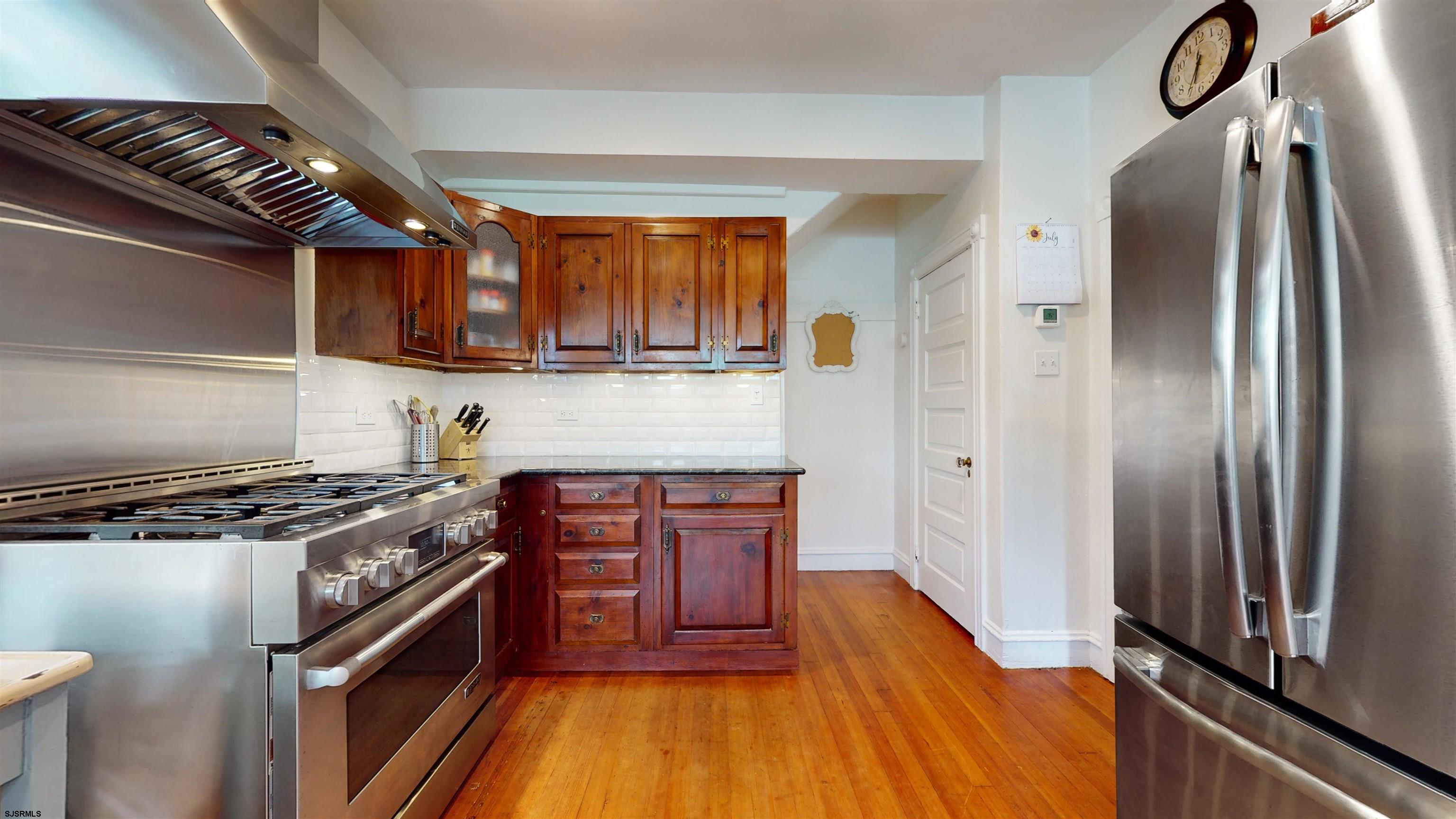 1409 Shore Road Northfield, NJ 08225 - Photo 19 of 50 a kitchen with stainless steel appliances granite countertop a stove a refrigerator and a sink
