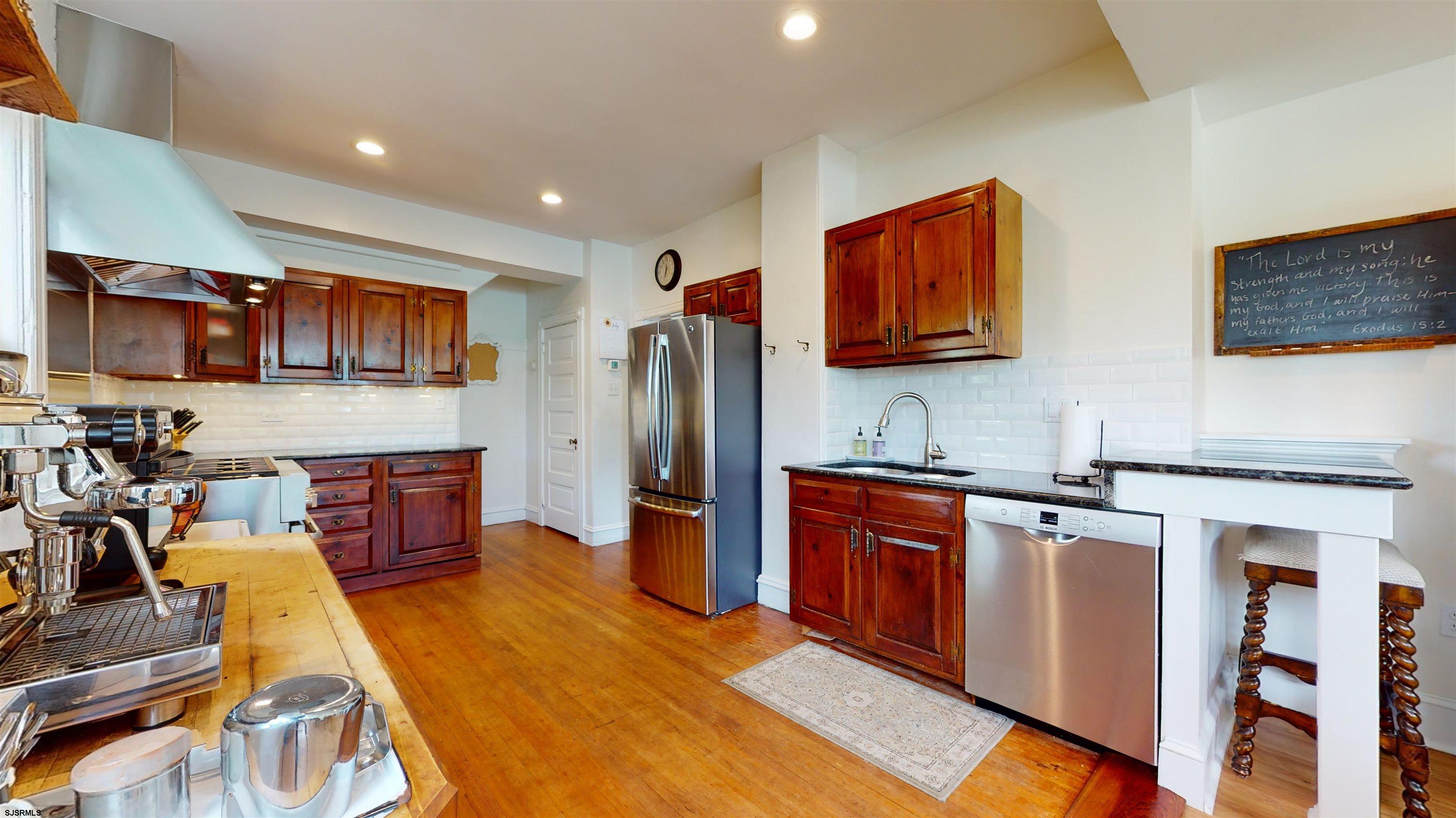 1409 Shore Road Northfield, NJ 08225 - Photo 21 of 50 a kitchen with stainless steel appliances granite countertop wooden cabinets sink and stove