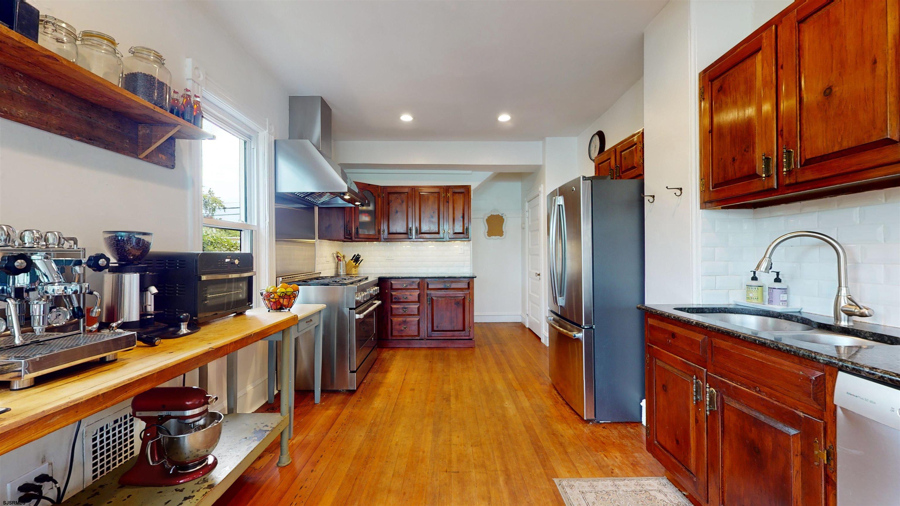 1409 Shore Road Northfield, NJ 08225 - Photo 22 of 50 a kitchen with stainless steel appliances granite countertop a refrigerator and a stove top oven