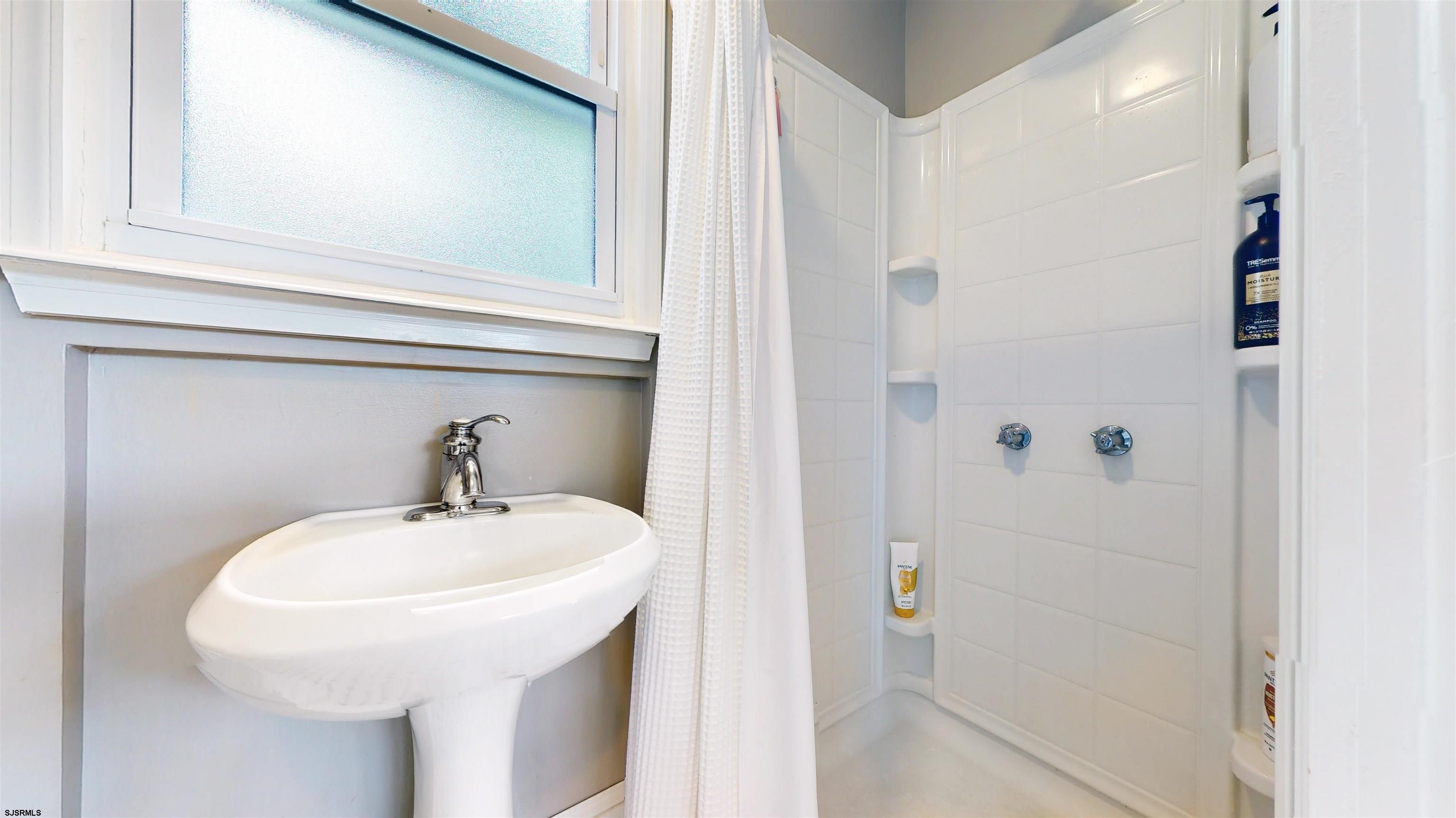 1409 Shore Road Northfield, NJ 08225 - Photo 26 of 50 a bathroom with a sink and a mirror