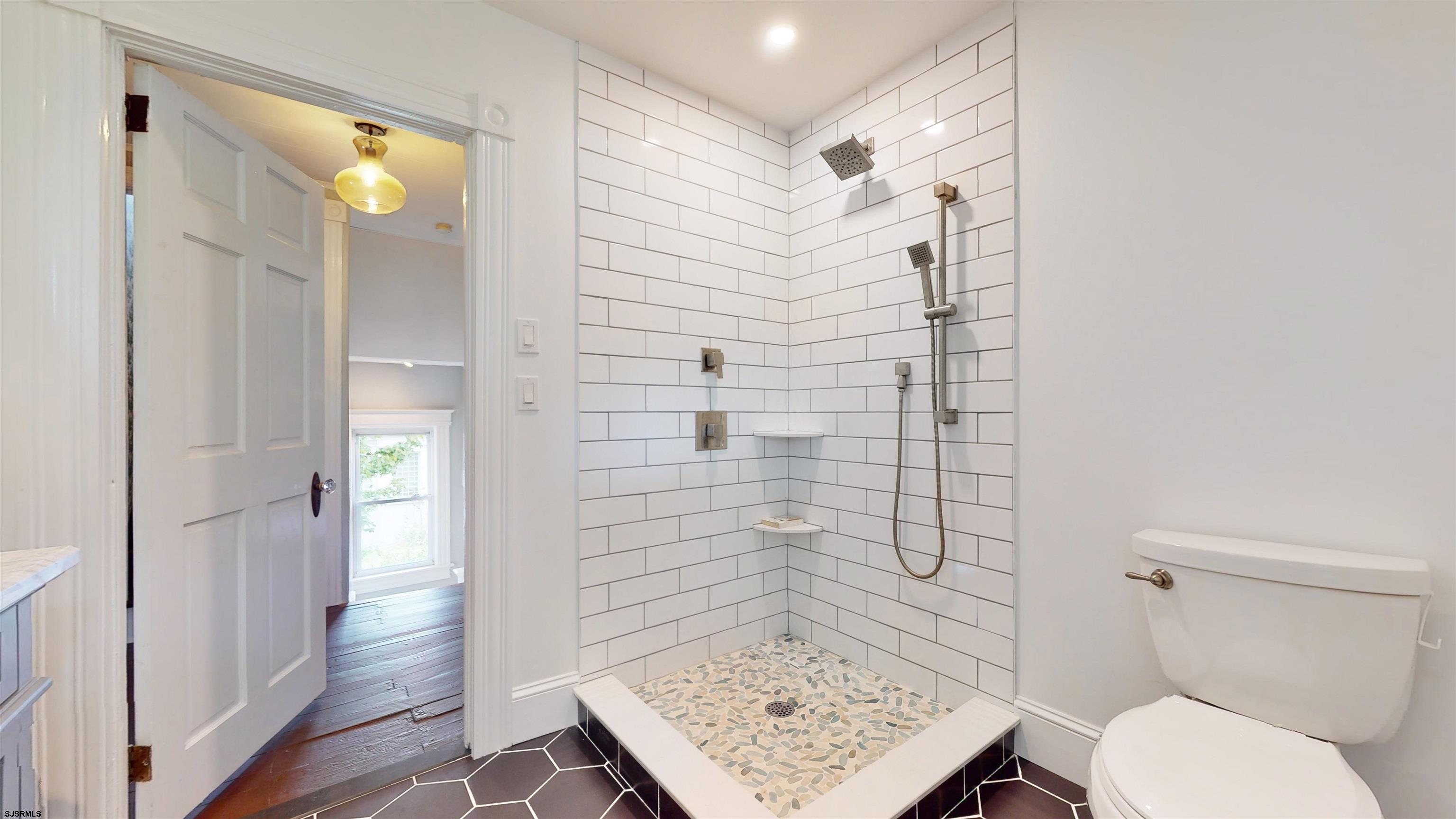 1409 Shore Road Northfield, NJ 08225 - Photo 28 of 50 a bathroom with a toilet and a shower