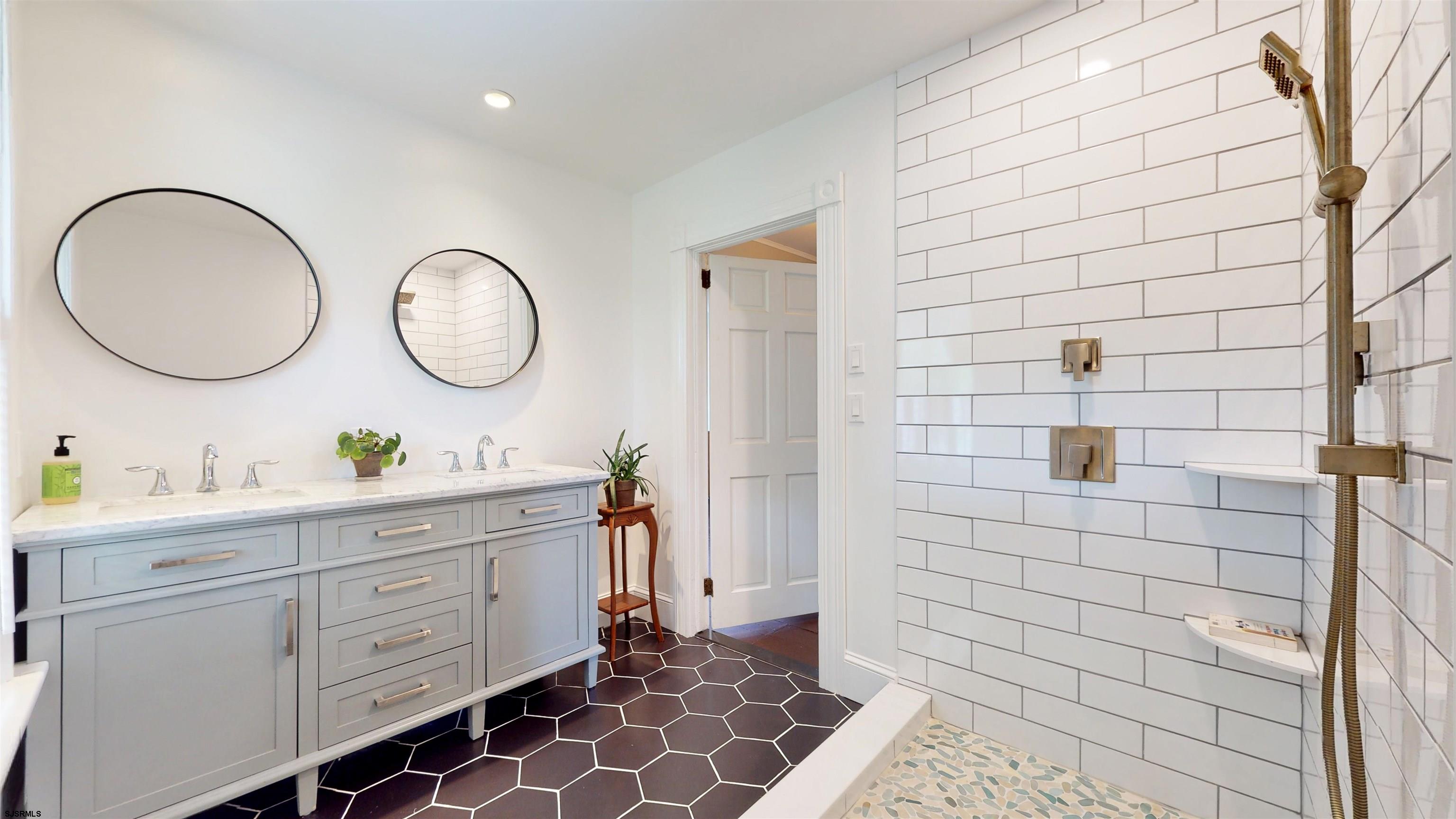 1409 Shore Road Northfield, NJ 08225 - Photo 29 of 50 a bathroom with a double vanity sink and a mirror