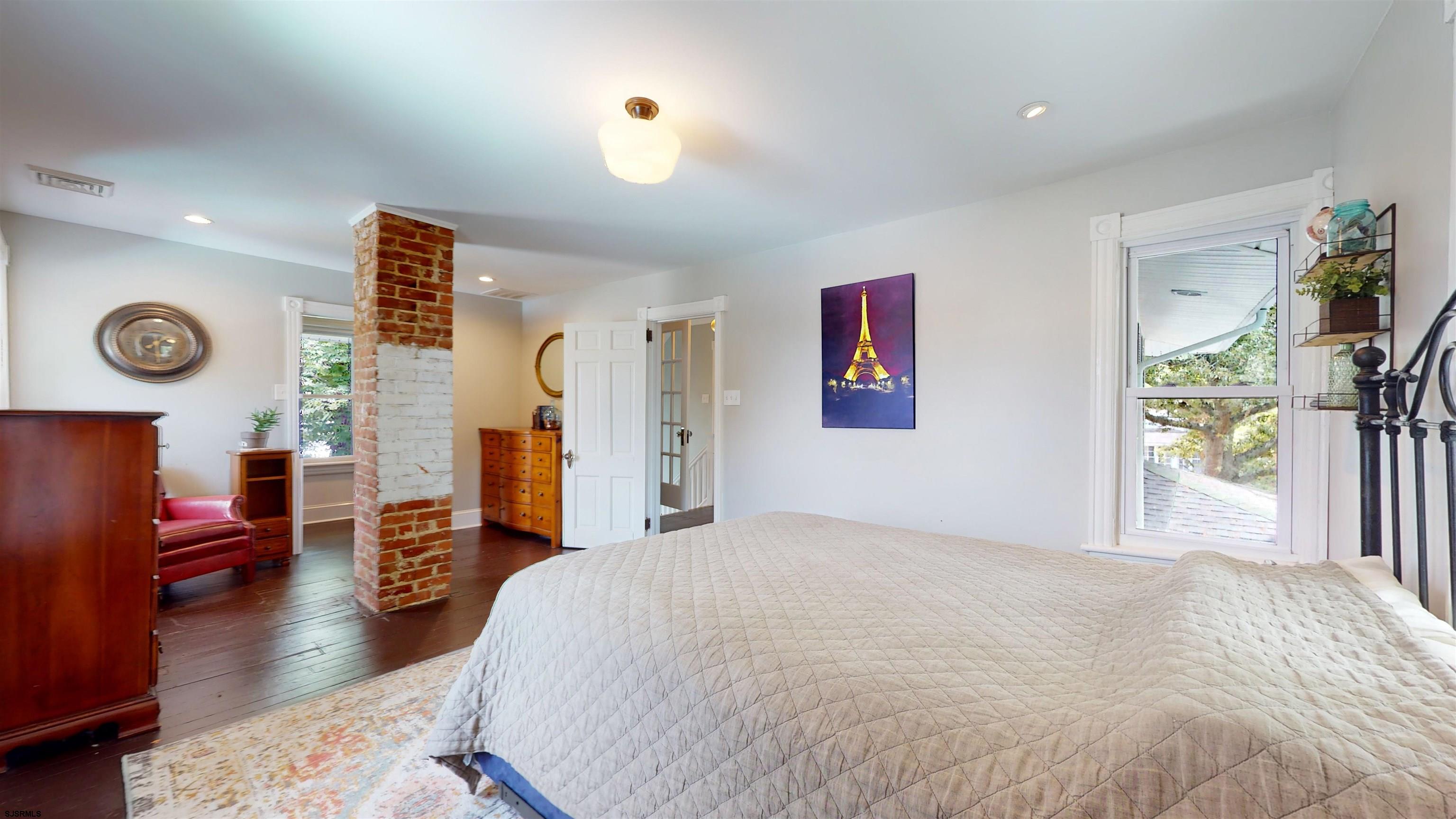 1409 Shore Road Northfield, NJ 08225 - Photo 33 of 50 a bedroom with a bed and wooden floor