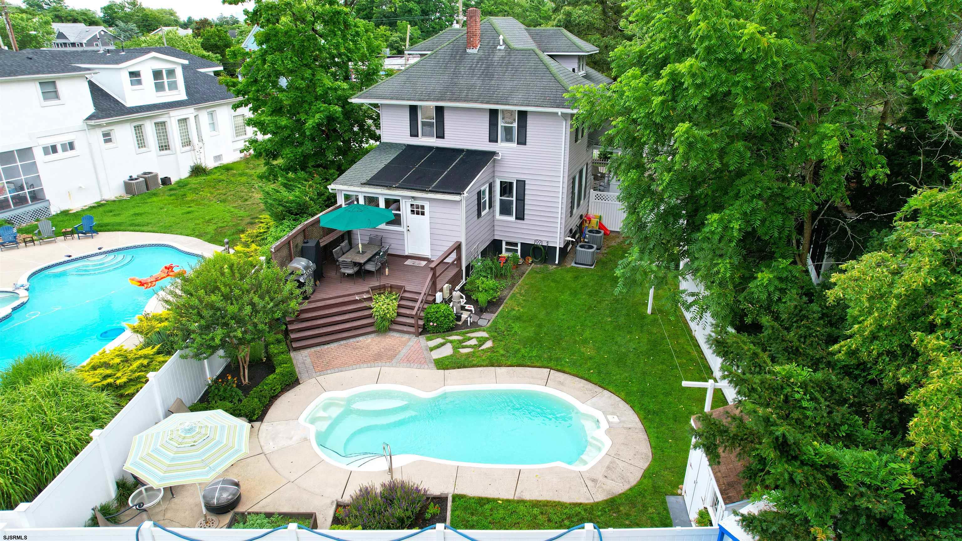 1409 Shore Road Northfield, NJ 08225 - Photo 8 of 50 a aerial view of a house with a yard and trees