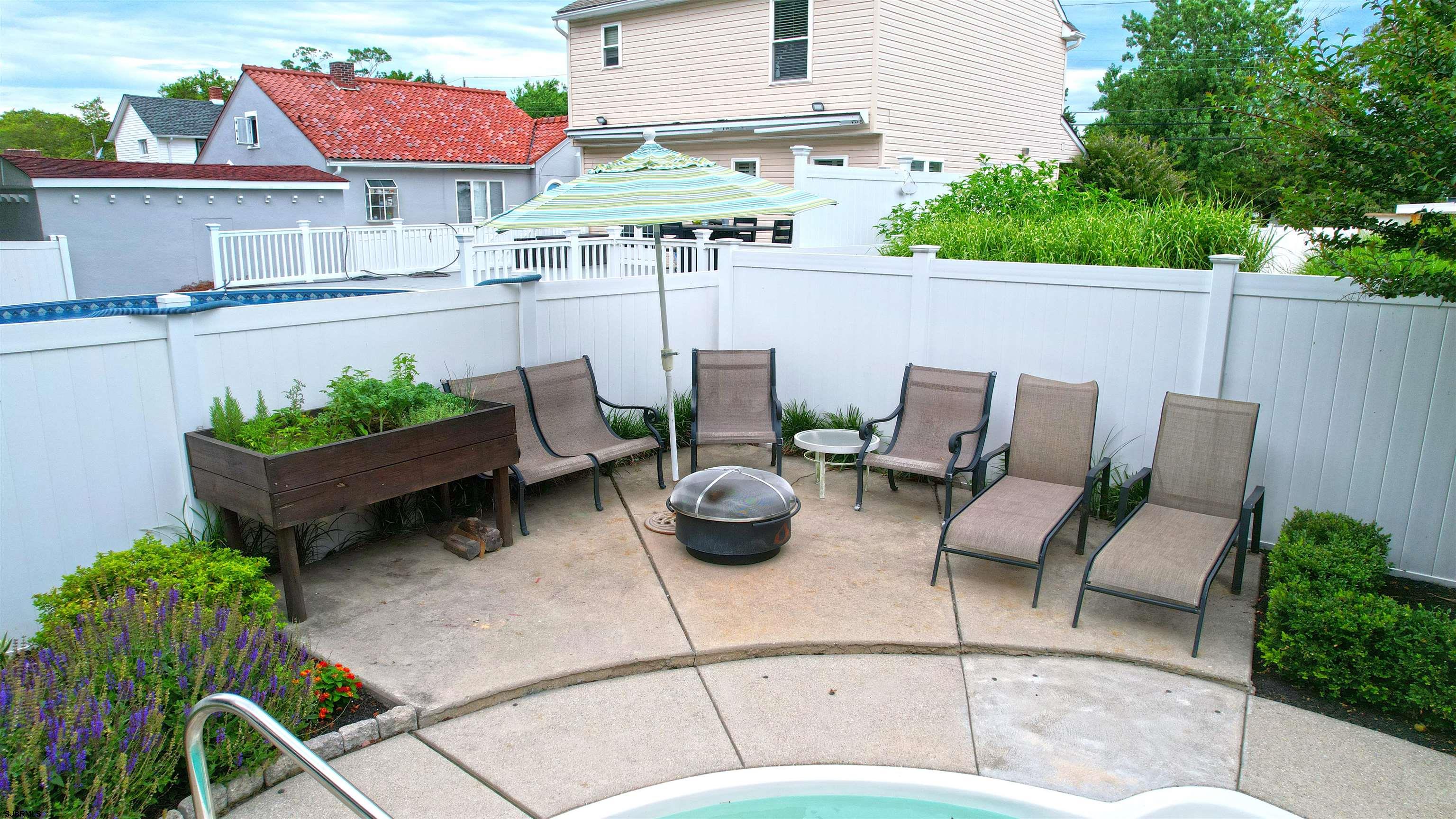 1409 Shore Road Northfield, NJ 08225 - Photo 10 of 50 a view of a patio with couches table and chairs potted plants and palm tree