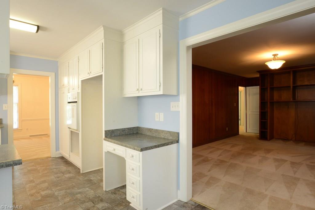 910 Wimbledon Place High Point, NC 27262 - Photo 16 of 30 Kitchen opens into pecan paneled den with built ins