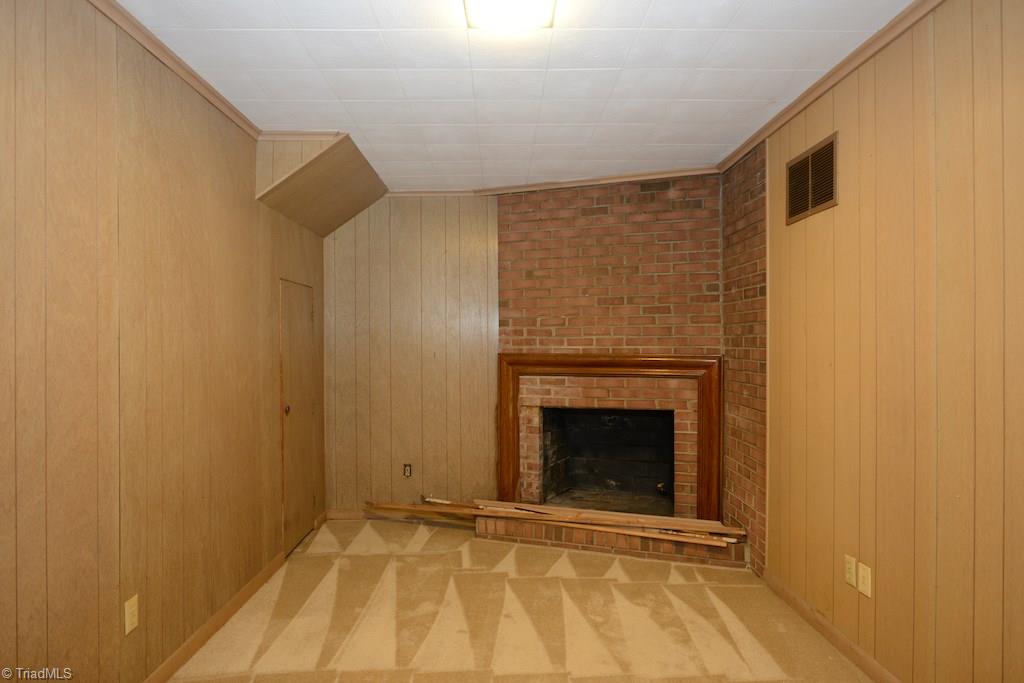 910 Wimbledon Place High Point, NC 27262 - Photo 30 of 30 Basement has wood burning fireplace and also a "potty closet" There is a laundry sink right outside in the laundry area