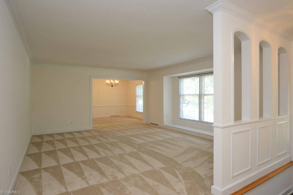 910 Wimbledon Place High Point, NC 27262 - Photo 8 of 30 enormous living room opens into dining room (per seller, there are immaculate hardwoods under this carpet)