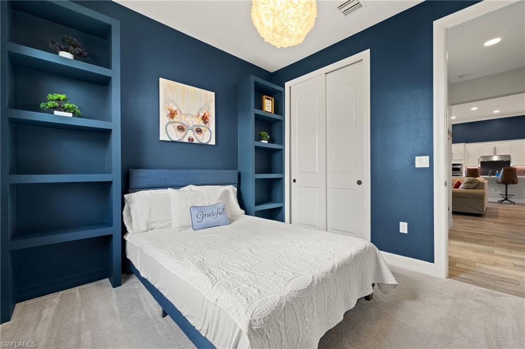 4424 Owens Way Ave Maria, FL 34142 - Photo 14 of 28 a bedroom with a bed and a lamp on table