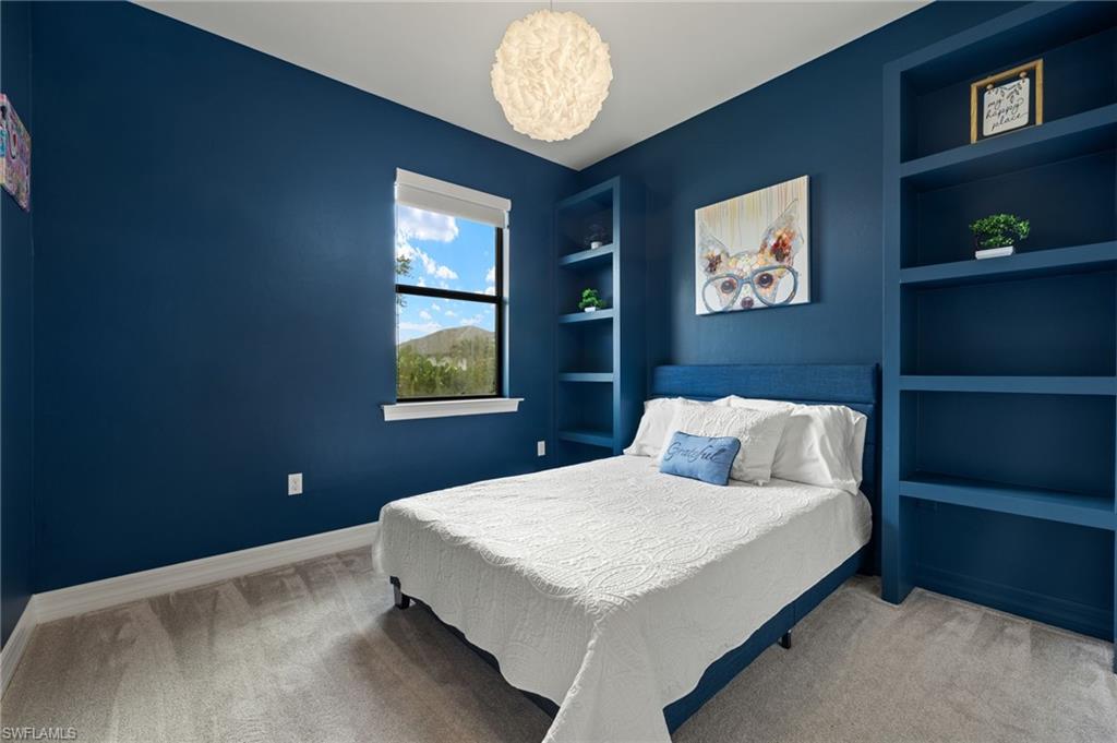 4424 Owens Way Ave Maria, FL 34142 - Photo 15 of 28 a bedroom with a bed and a window