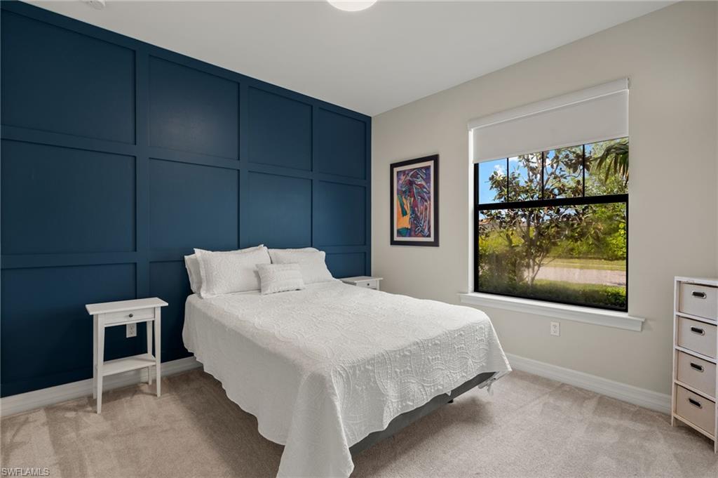 4424 Owens Way Ave Maria, FL 34142 - Photo 17 of 28 a bedroom with a bed and large window