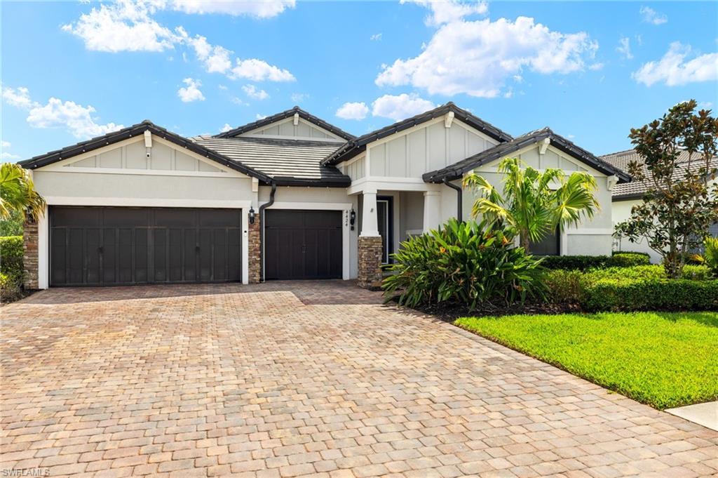 4424 Owens Way Ave Maria, FL 34142 - Photo 2 of 28 a front view of a house with a yard and garage