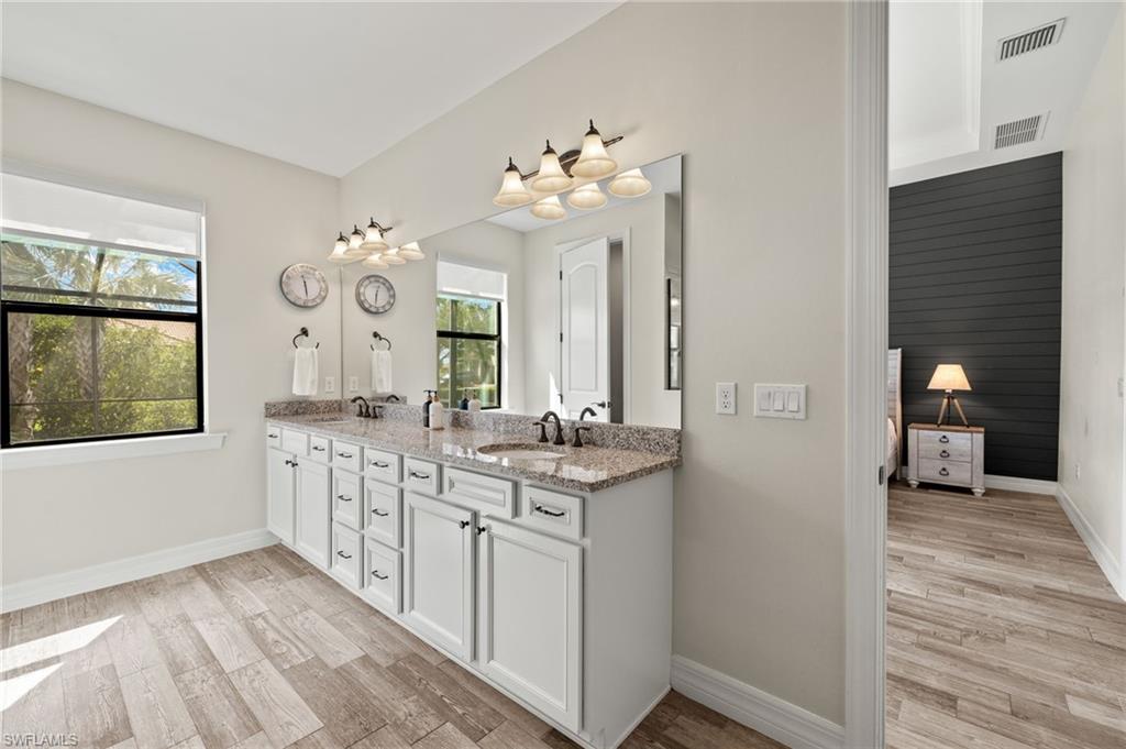 4424 Owens Way Ave Maria, FL 34142 - Photo 21 of 28 a bathroom with a sink vanity and a mirror