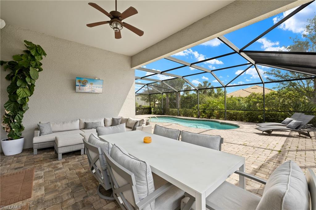 4424 Owens Way Ave Maria, FL 34142 - Photo 3 of 28 a view of a patio with a table and chairs under an umbrella