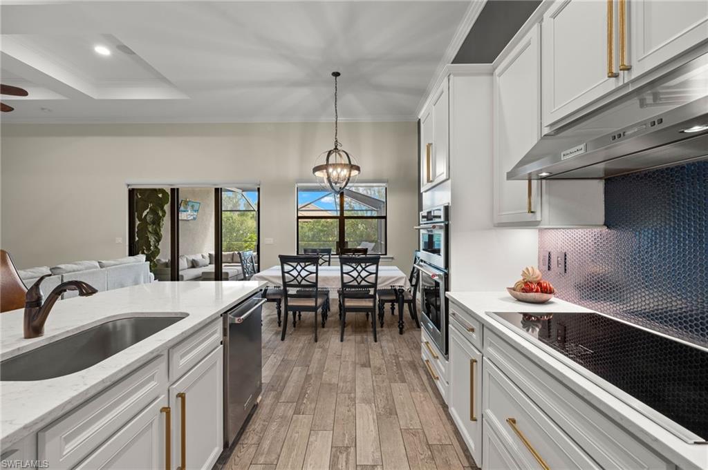 4424 Owens Way Ave Maria, FL 34142 - Photo 8 of 28 a kitchen with granite countertop a sink stove and cabinets