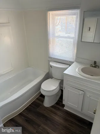 a bathroom with a sink a toilet and bathtub