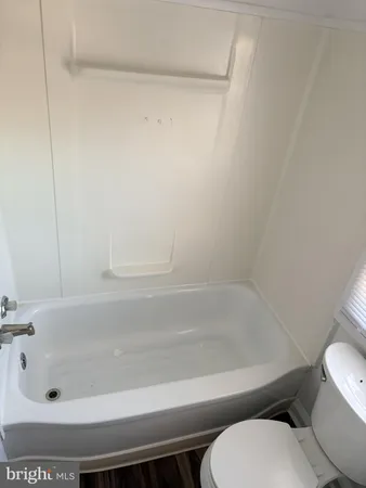 a bathroom with a toilet and bathtub