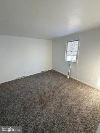 an empty room with a empty space and a window