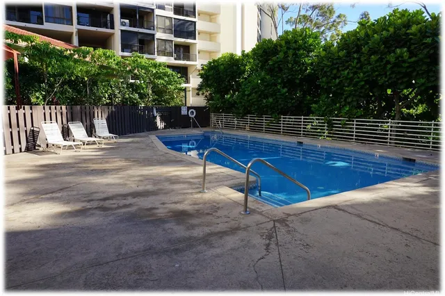 a view of a tennis ground with large trees