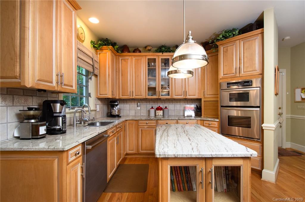 7074 Harbor Court Tega Cay, SC 29708 - Photo 14 of 36 a kitchen with stainless steel appliances granite countertop a sink refrigerator and cabinets