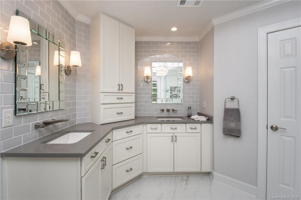 7074 Harbor Court Tega Cay, SC 29708 - Photo 22 of 36 a spacious bathroom with a double vanity sink a mirror and a shower