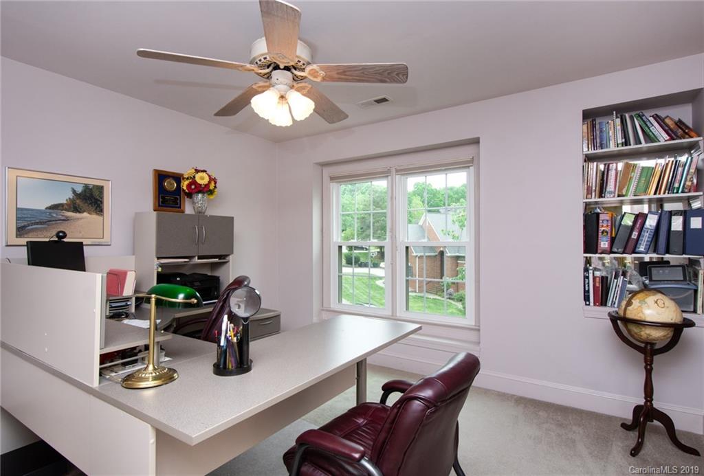 7074 Harbor Court Tega Cay, SC 29708 - Photo 23 of 36 a living room with furniture and a bookshelf
