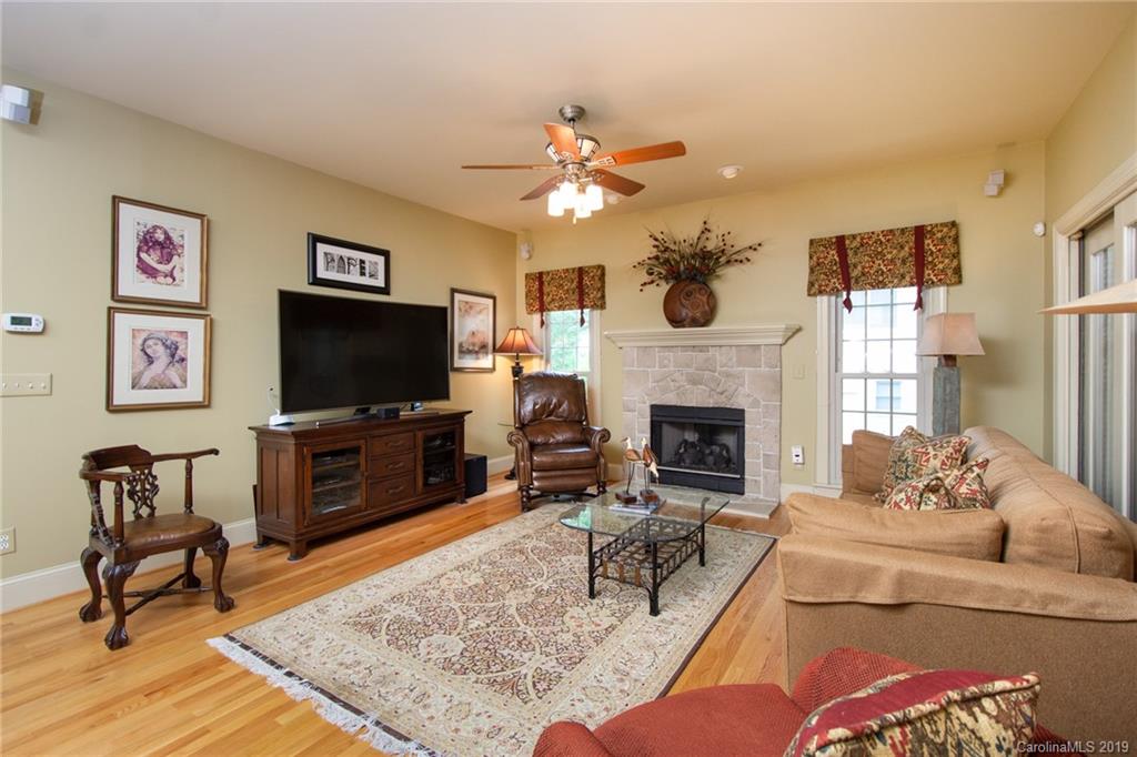 7074 Harbor Court Tega Cay, SC 29708 - Photo 10 of 36 a living room with furniture a flat screen tv and a fireplace