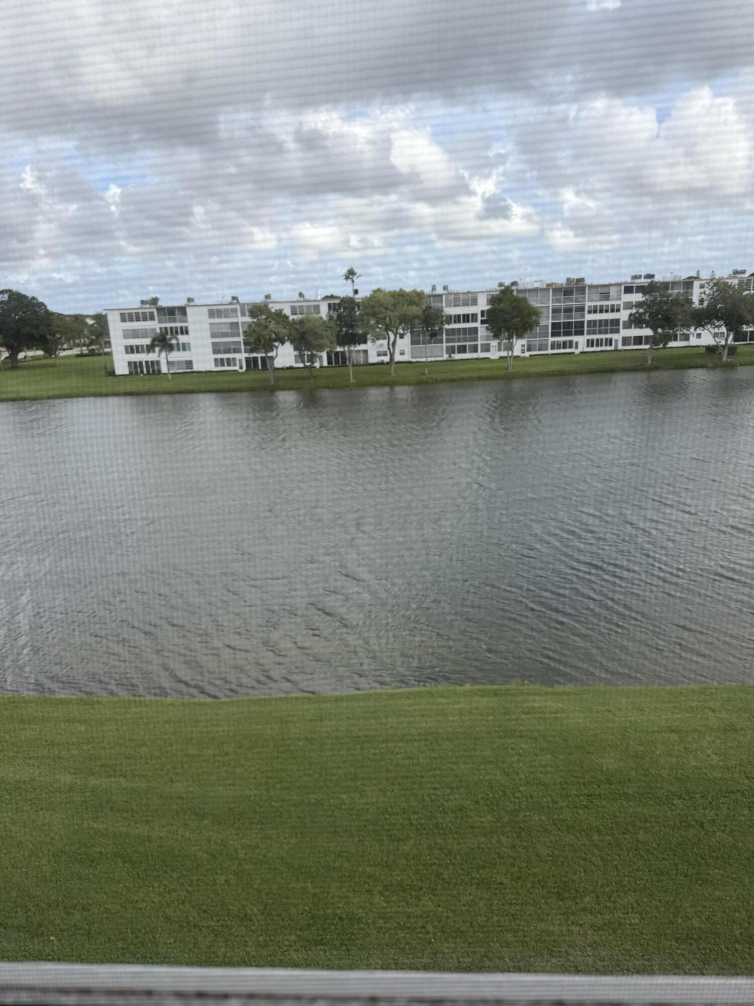 4067 Yarmouth C Boca Raton, FL 33434 - Photo 38 of 40 a view of a lake with houses in the back