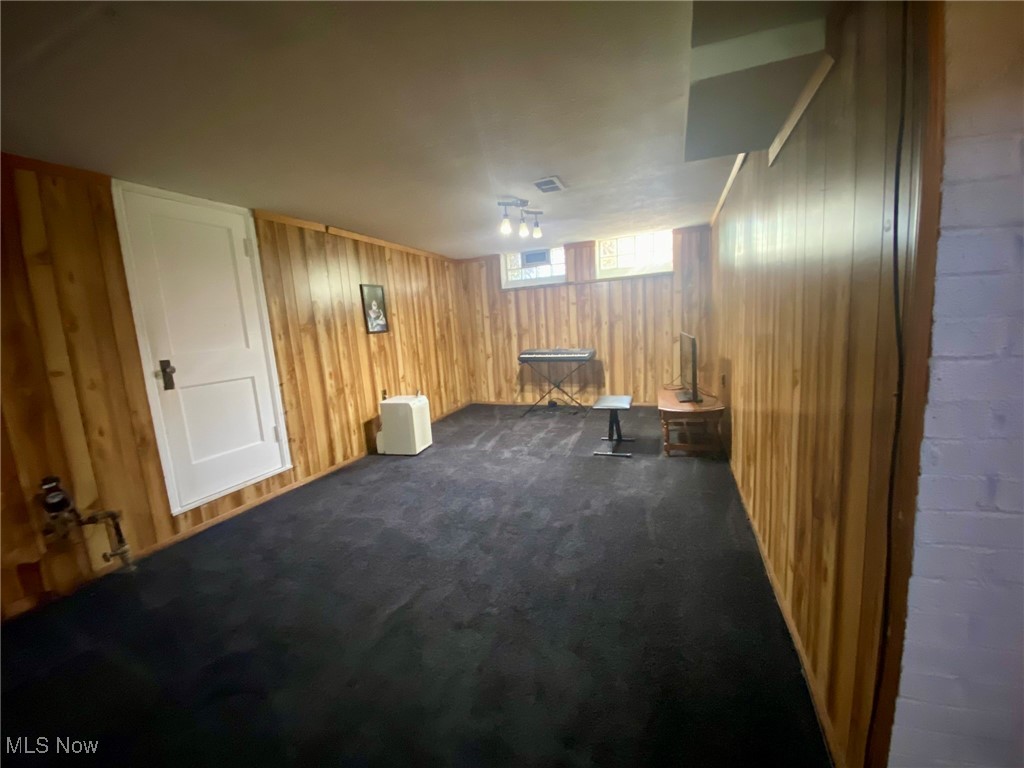 1568 Sunview Road Cleveland, OH 44124 - Photo 31 of 50 Basement featuring wooden walls and dark colored carpet
