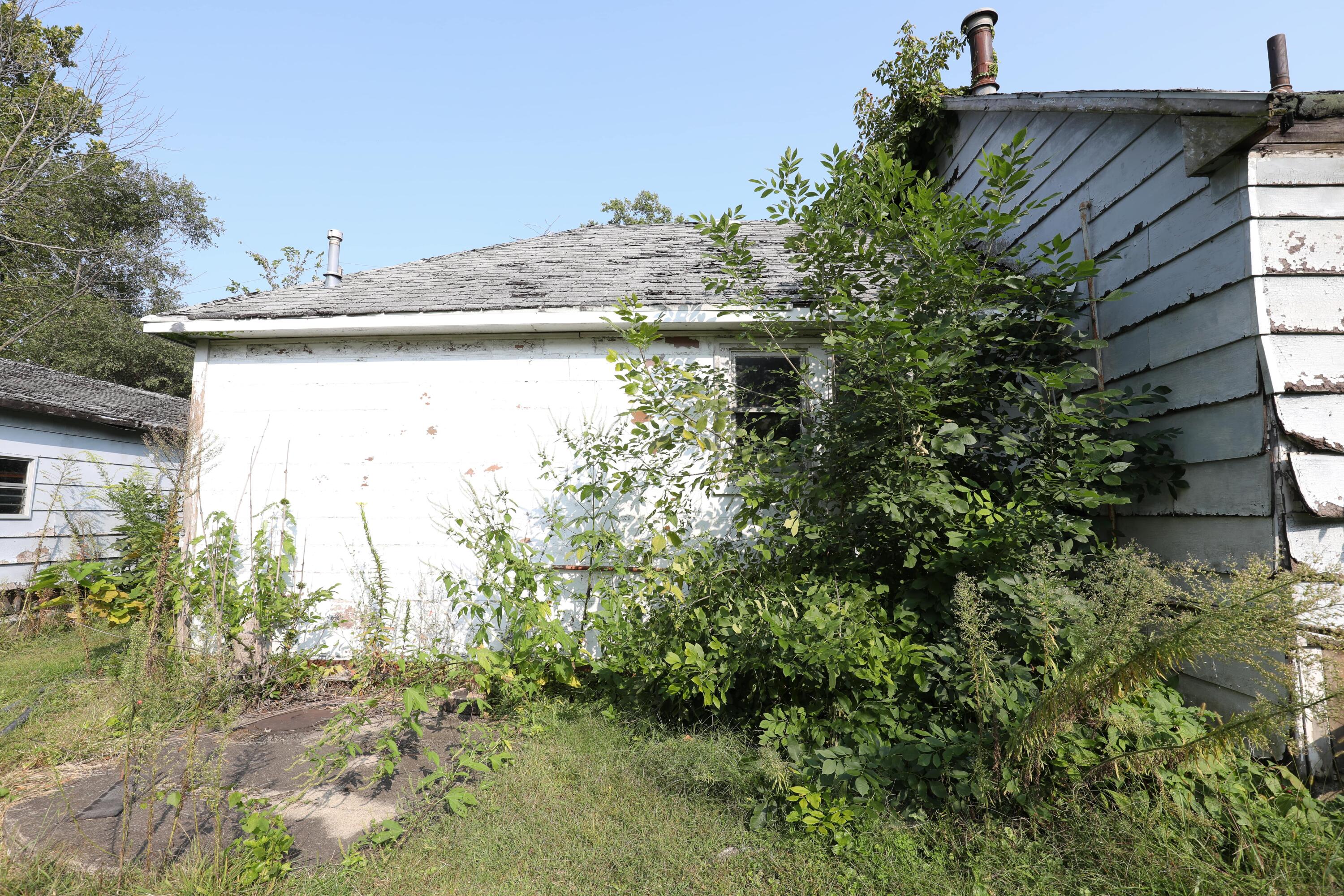 15 East Oneida Street La Crosse, IN 46348 - Photo 15 of 21 a view of a house with a yard and plants