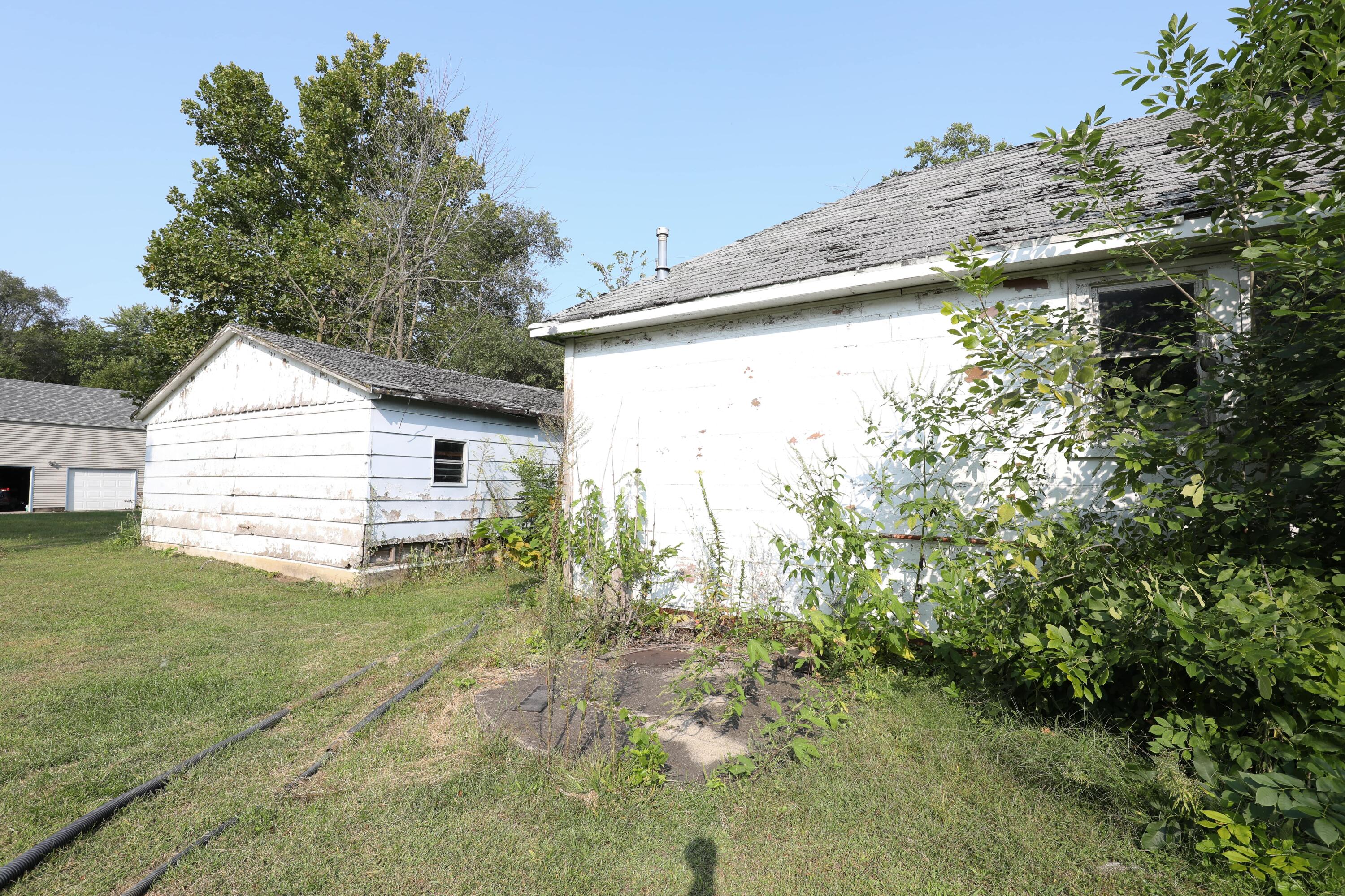 15 East Oneida Street La Crosse, IN 46348 - Photo 17 of 21 a view of a house with a yard and garage