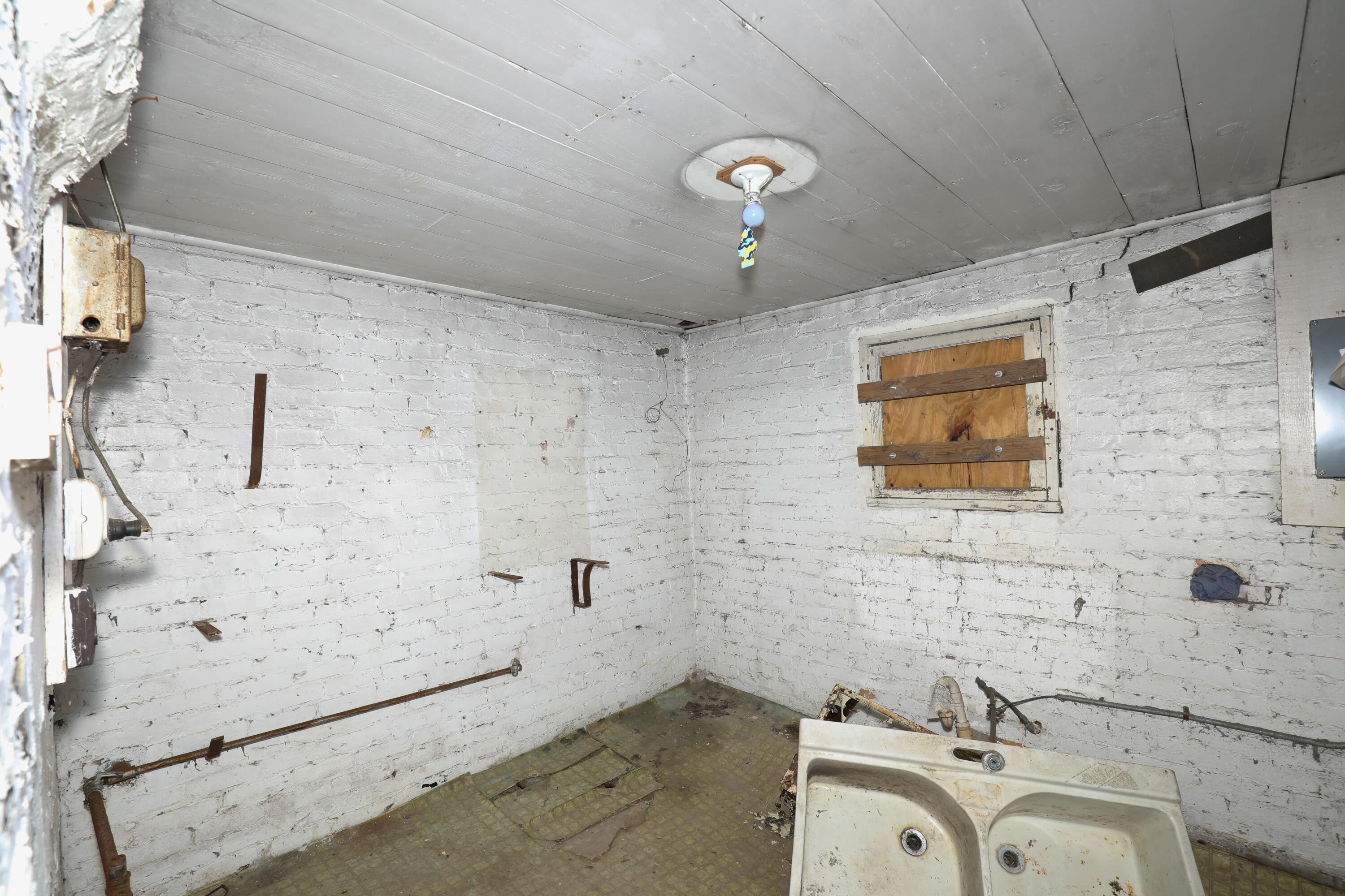 15 East Oneida Street La Crosse, IN 46348 - Photo 9 of 21 a bathroom with a sink and a shower