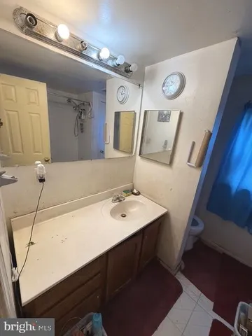 a bathroom with a sink vanity and mirror