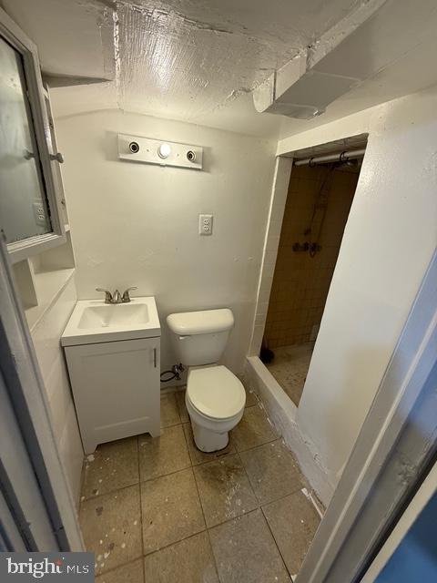 2205 Calvert Street Hyattsville, MD 20783 - Photo 17 of 26 a white toilet sitting next to a white sink and vanity