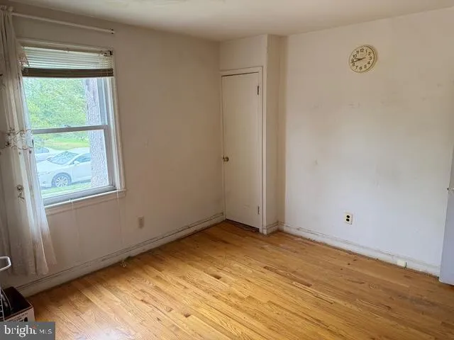 a view of room with window and wooden floor