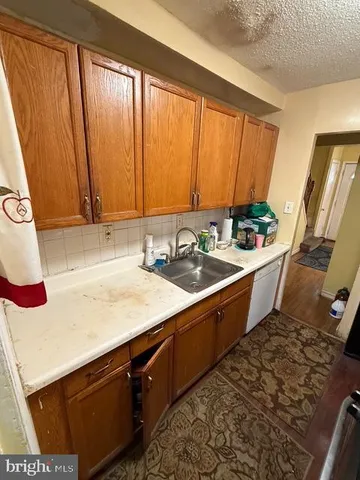 a room with a sink cabinets and a chair