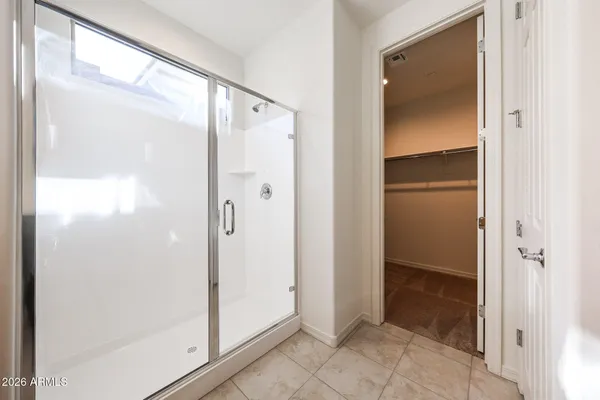 a bathroom with a glass shower door