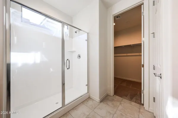 a bathroom with a glass shower door