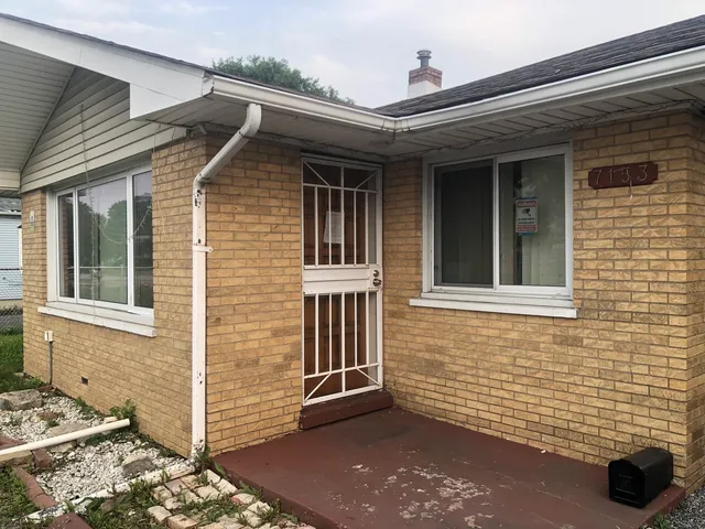 a view of a brick house with many windows