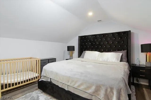 a large bed sitting in a bedroom next to a lamp