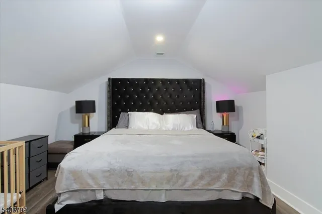 a bedroom with a bed and a night stand